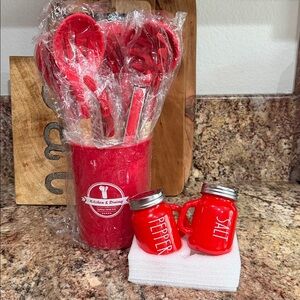 Red kitchen utensils and salt and pepper shakers